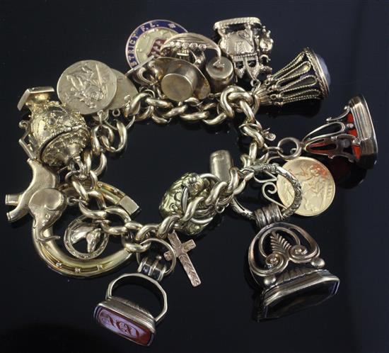 A 9ct gold charm bracelet hung with approximately nineteen assorted charms